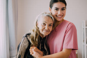 A caregiver hugs her patient at the memory care facility.