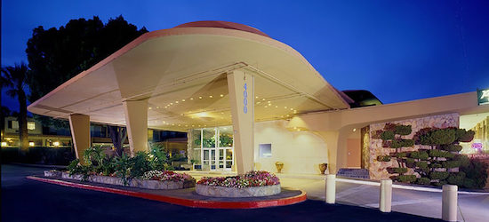 The villa at San Mateo main entrance, decorated with flower patches and warm lights at sunset