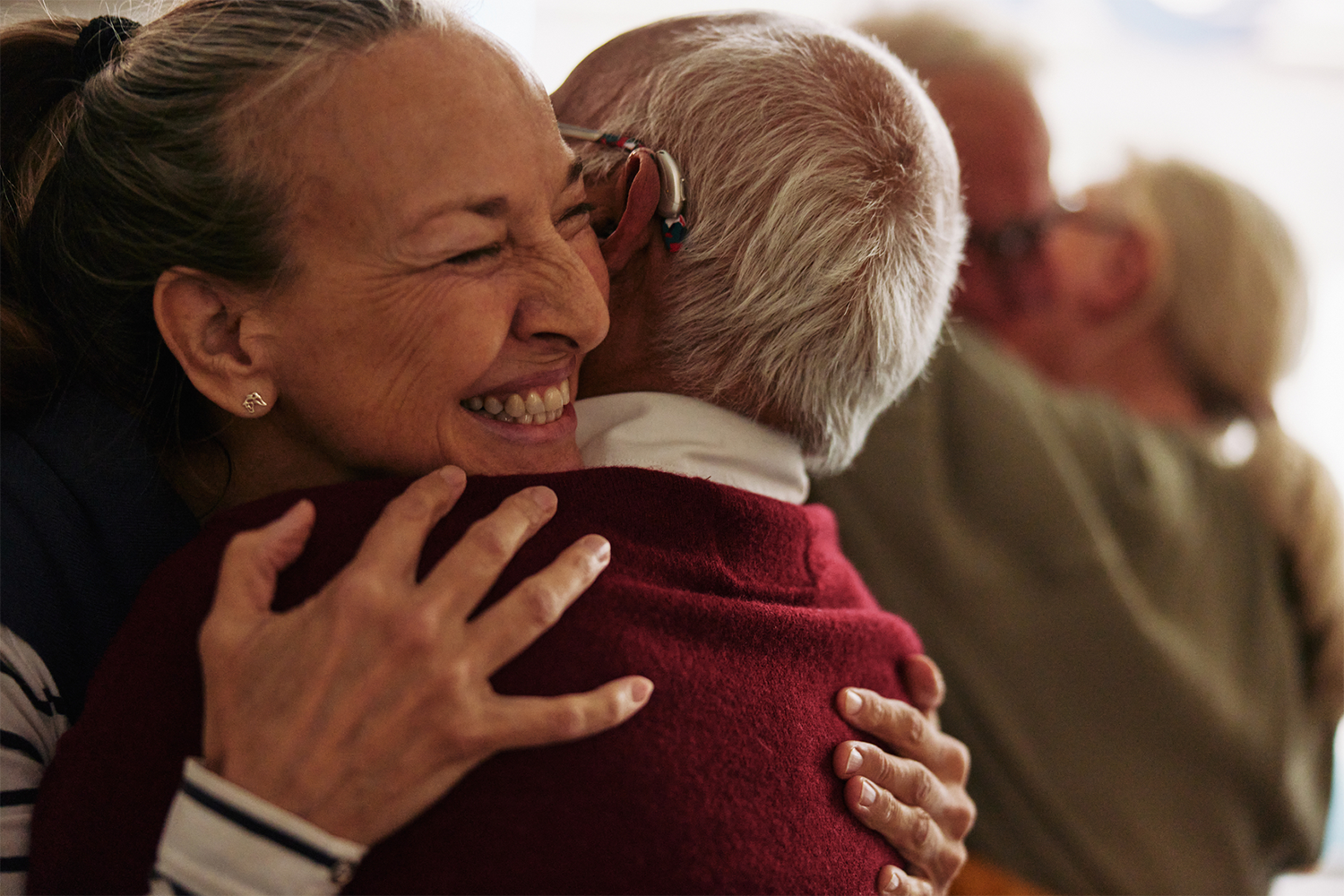 An image of a woman hugging an elderly man