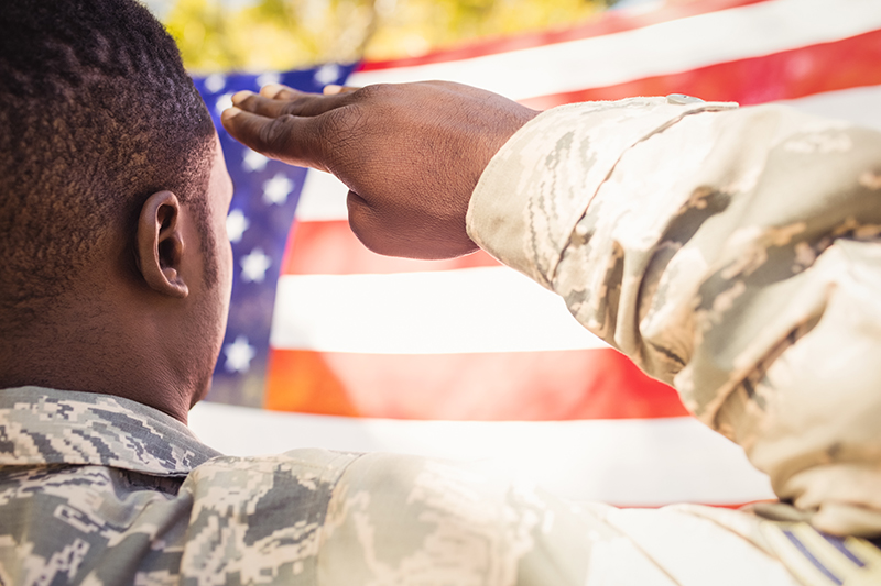 A member of the U.S. military salutes the flag to honor his country and thank veterans who have fought for it.