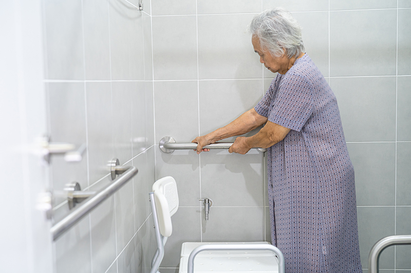 Asian senior or elderly old lady woman patient use toilet bathro