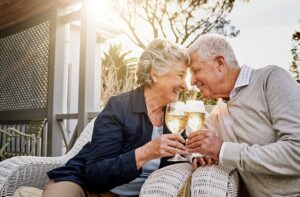 Dating Again For Seniors. Older man and woman cheers wine glasses.