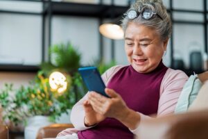 Navigating Social Media for Older Adults. Senior woman using smartphone.