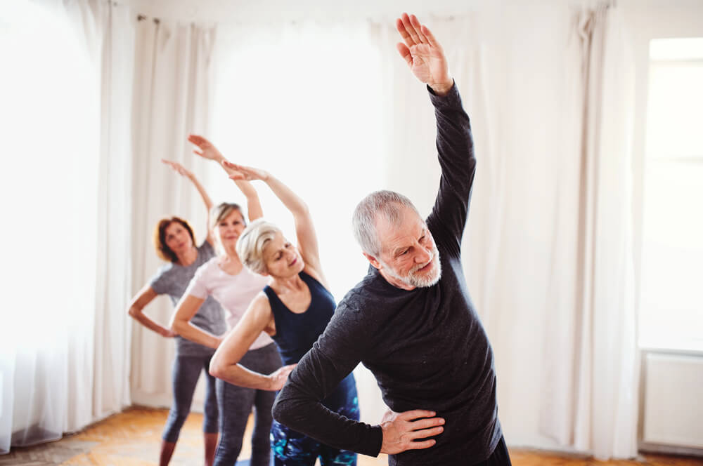 How does a side bend and reach exercise help seniors?