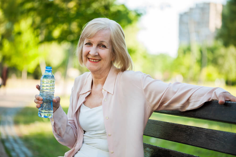 Carrying a water bottle with you throughout the day is a way to help seniors ensure they drink enough water. 