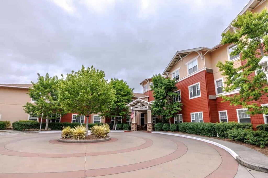 AlmaVia Of San Rafael living facilities, suburban design with trees and bushes in a sunny day