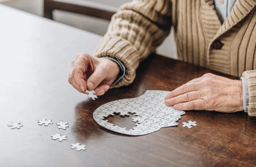 Elderly person assembling a puzzle.