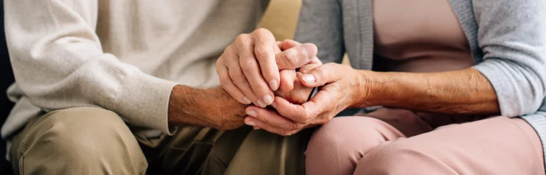 Two hands holding each other gently.