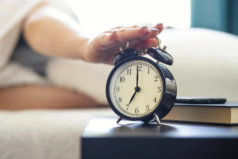 Hand reaching for alarm clock