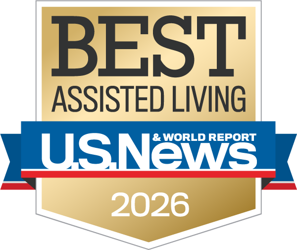 Gold badge reading "Best Senior Living U.S. News & World Report 2026" with a blue, red, and white ribbon design, awarded to AlmaVia of San Francisco and AlmaVia of Camarillo.