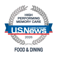 U.S. News & World Report logo with white text on a blue background, partially overlaid on a grey circular graphic, highlights the recognition of Camarillo senior living communities.