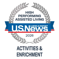 U.S. News & World Report logo featuring a blue and red banner with the publication name inside a gray circular emblem, highlighting AlmaVia of San Francisco as a top assisted living and senior living community.