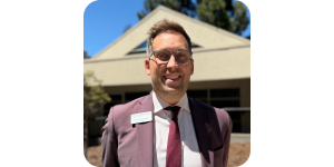 Kel Strohgren, Executive Director at Mercy Retirement & Care Center, wearing a suit and glasses.