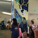 students and senior residents view murals