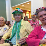 senior residents smile at the camera during the summer solstice celebration