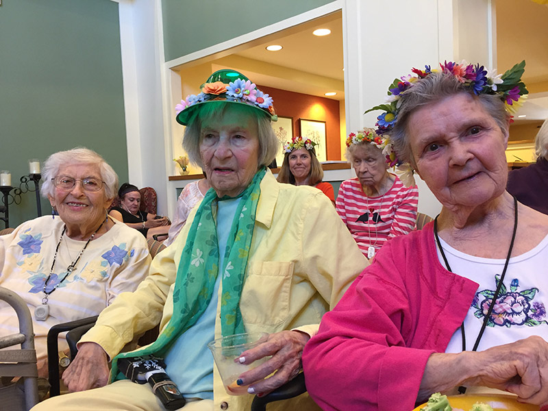senior residents smile at the camera during the summer solstice celebration